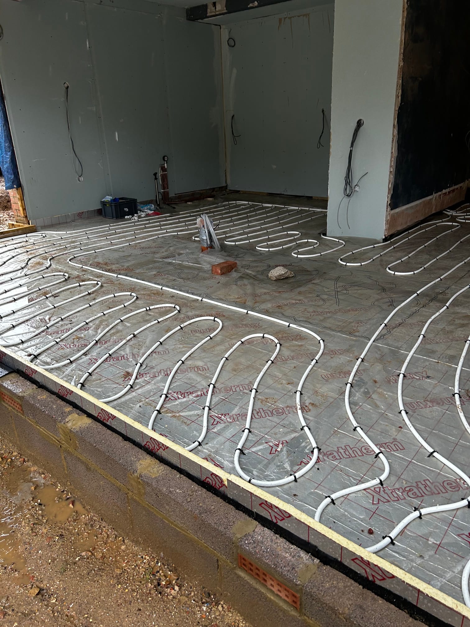 Underfloor heating pipework laid across a floor during installation