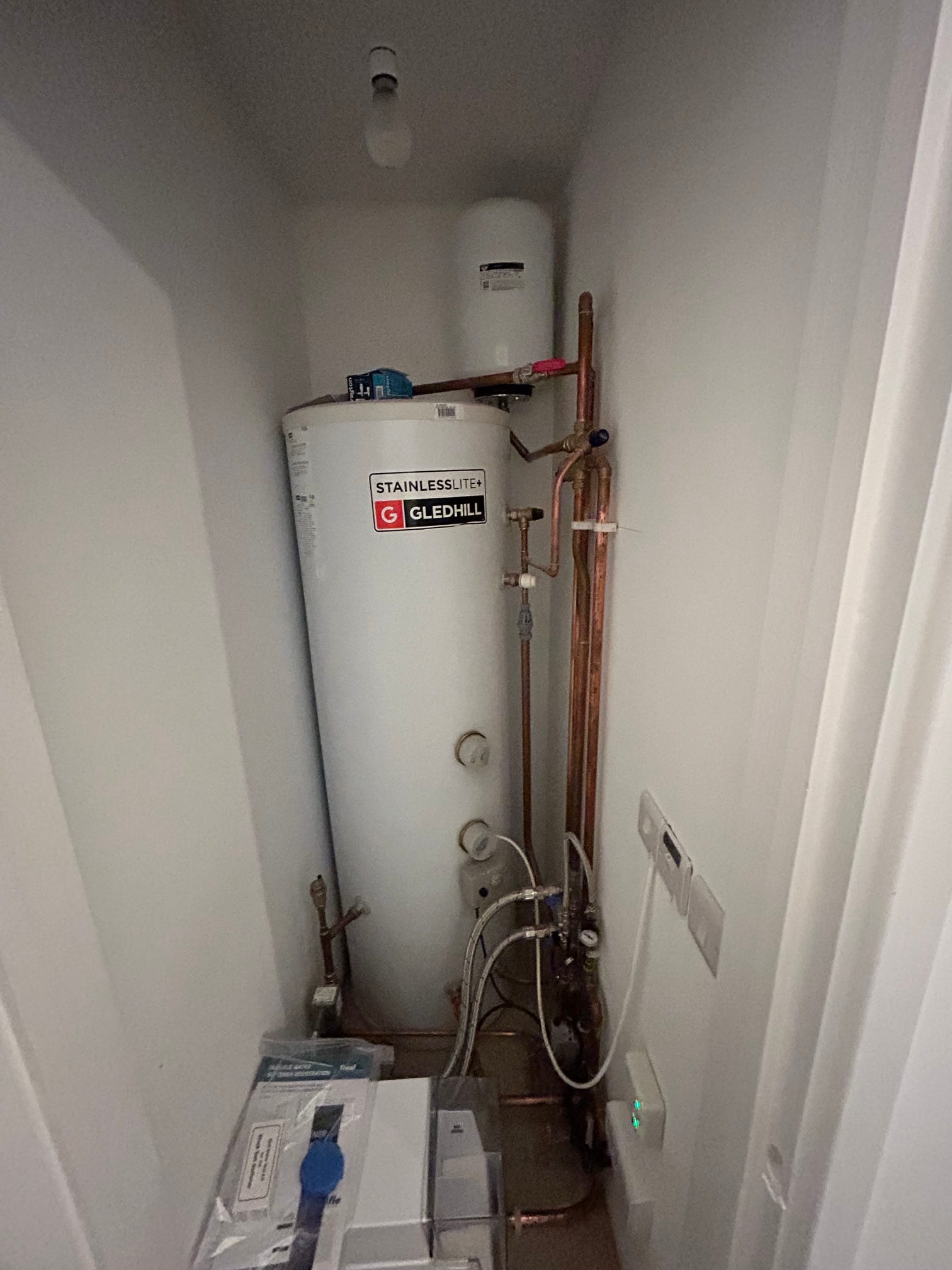 Unvented hot-water cylinder installed inside a cupboard