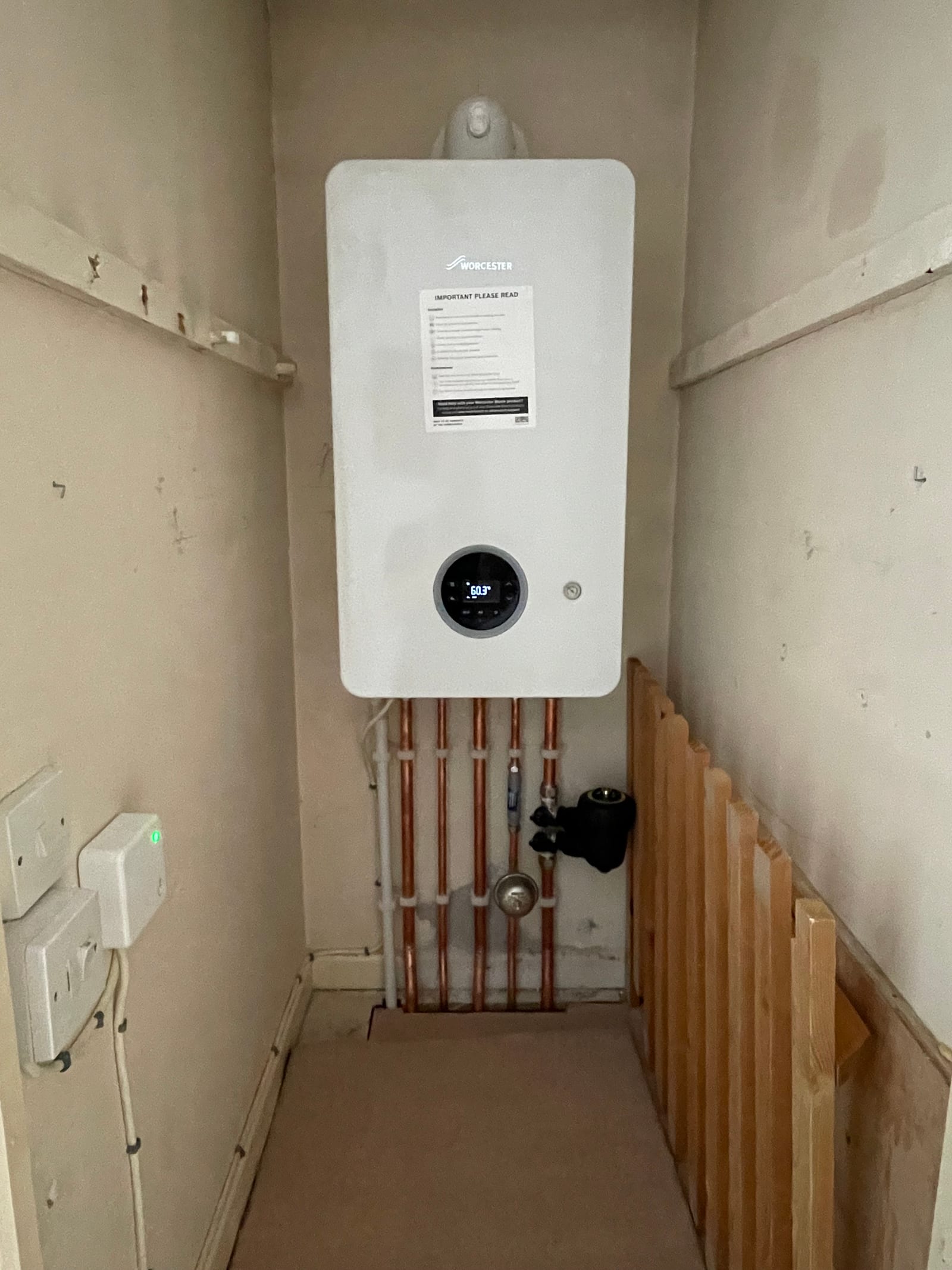 Wall-mounted Worcester boiler with neatly arranged copper pipework